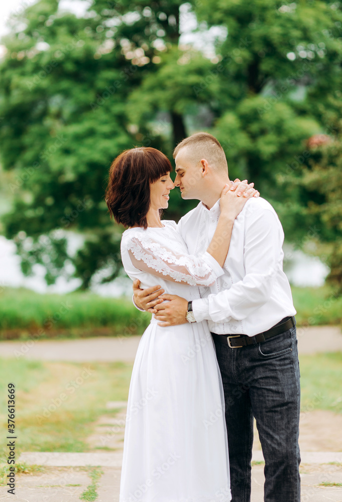Beautiful wedding couple posing in the park Beautiful wedding couple posing in the park