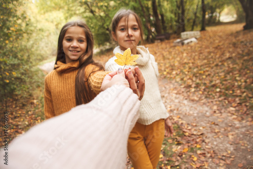 Woman hand holding a leaf to present the preteen kid