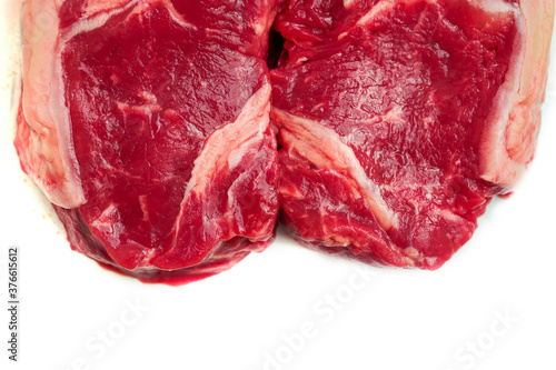 Two fresh strip loin steaks on a white isolated background. Meat industry product.