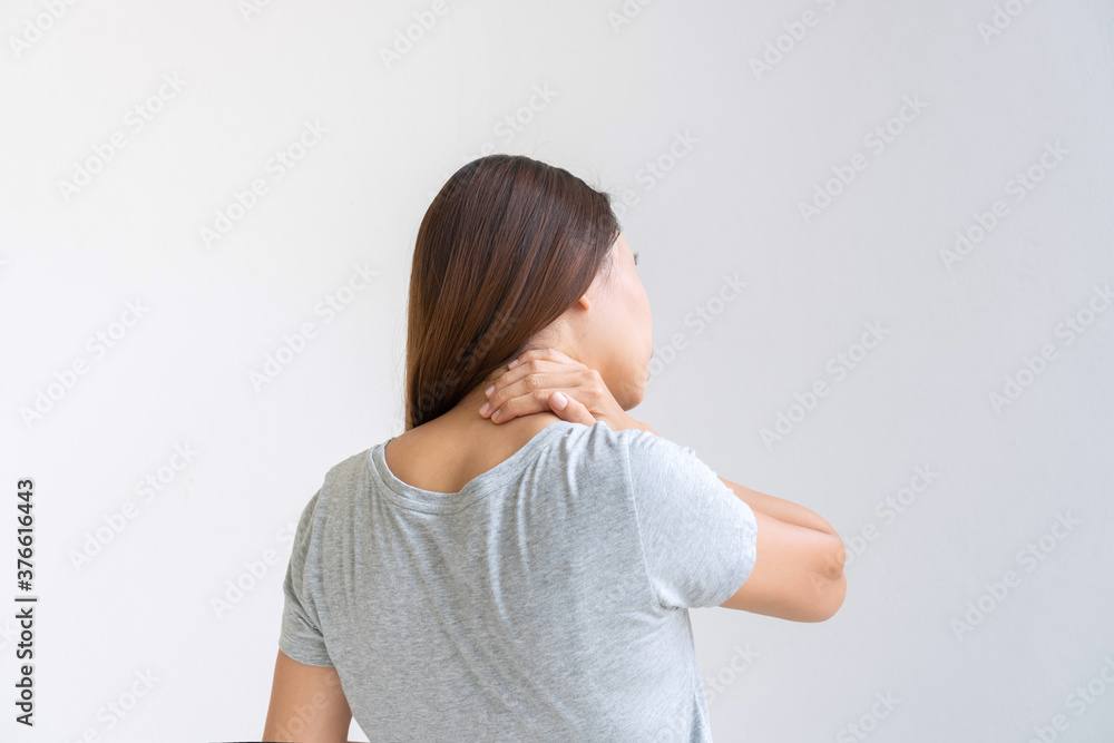 Back view of oung Asian woman suffering from neck pain isolated on white background, studio shot. Copy space, close up Back view of oung Asian woman suffering from neck pain isolated on white background, studio shot. Copy space, close up
