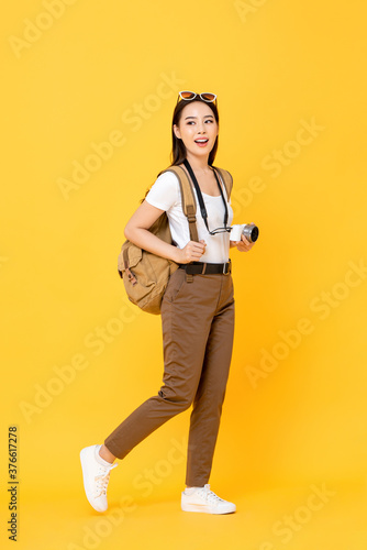 Photography Full length portrait of smiling cute young Asian woman tourist with camera walin
