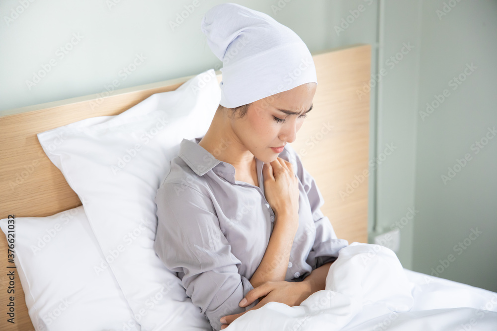 Portrait of sad asian woman cancer patient wearing head scarf after suffering serious hair loss due to chemotherapy Portrait of sad asian woman cancer patient wearing head scarf after suffering serious hair loss due to chemotherapy