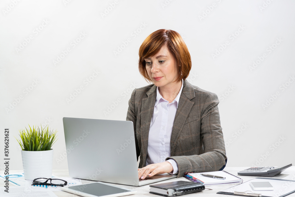 Busy adult businesswoman working with computer Busy adult businesswoman working with computer
