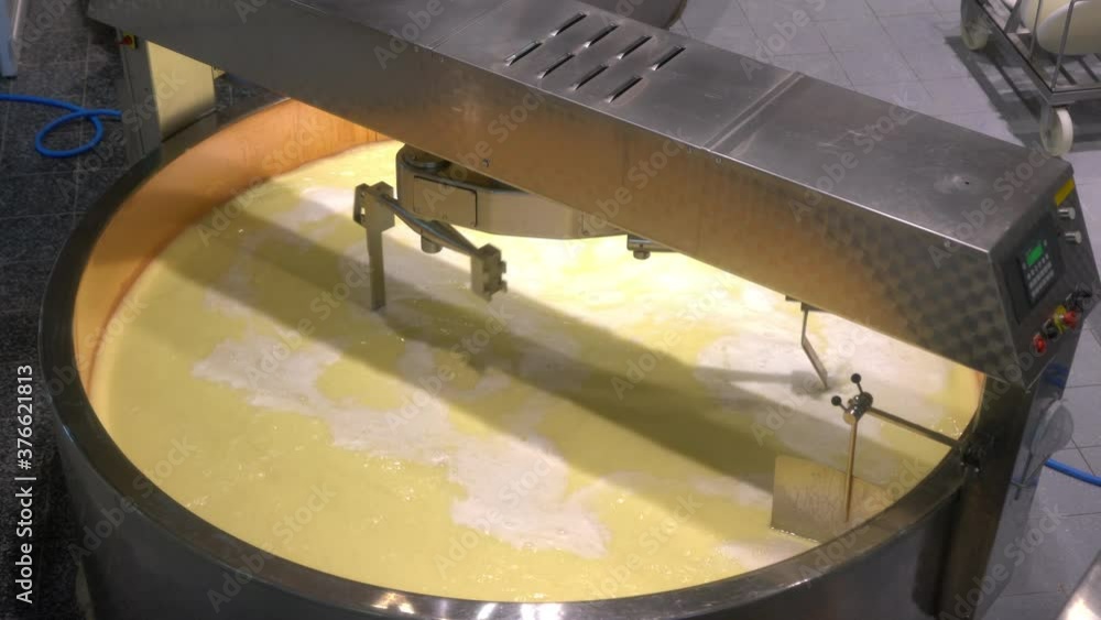 Swiss cheese factory with milk tank stirring and heating the curds and ...