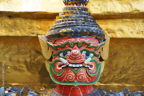 colorful tradition demon statue which support golden pagoda © sakhorn38
