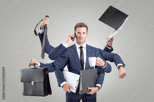 Funny portrait of a businessman with many arms photo