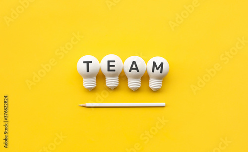 Business creativity and team concepts with lightbulb and pencil on yellow background.
