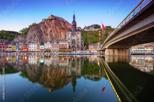 Dinant, Belgium. Cityscape image of beautiful historical city of Dinant with the reflection of the city in the Meuse River at summer sunset.
