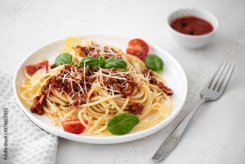 spaghetti with meat sauce, parmesan and basil