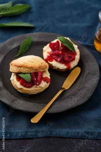 Traditional British Scones with clotted cream, raspberry jam. Scones with raspberry jam