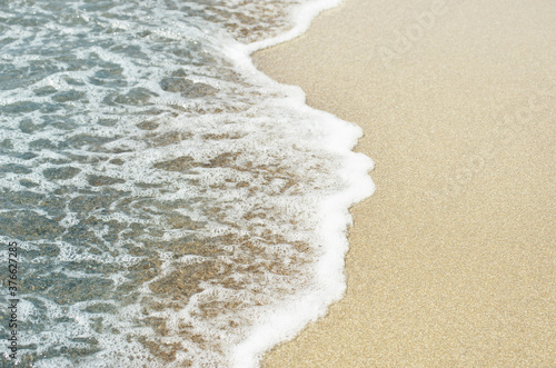 Fototapeta Naklejka Na Ścianę i Meble -  Soft wave of sea on sandy beach. Background.