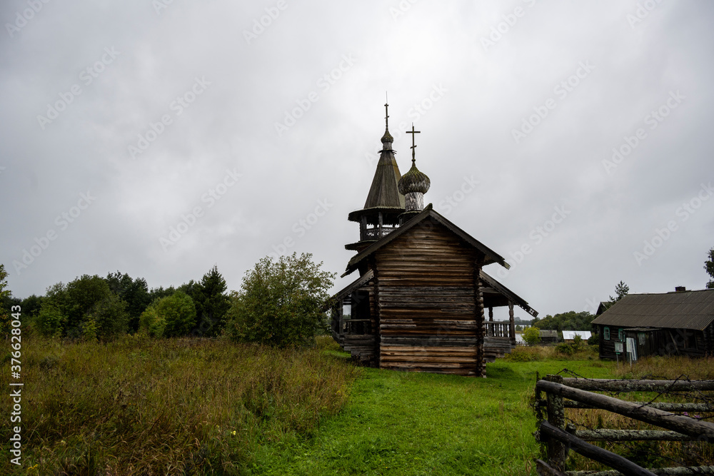wooden ancient church on the island among the trees during the rain wooden ancient church on the island among the trees during the rain