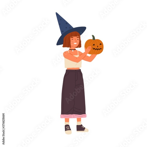 Cute happy girl wearing witch hat hold Halloween pumpkin. Funny portrait of j...