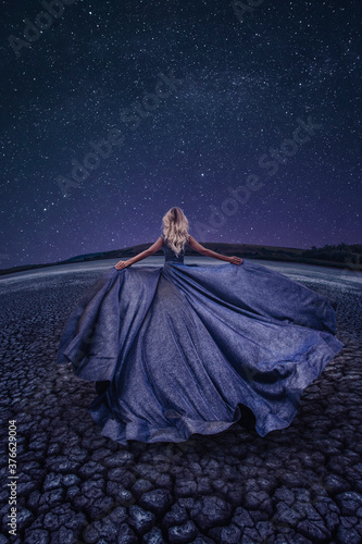 Beautiful woman in dry lake in the night