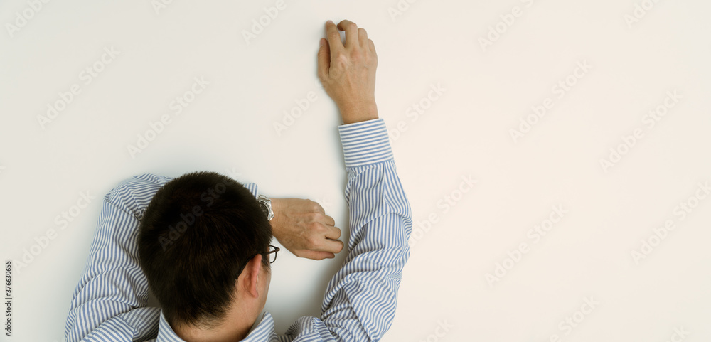 PTSD Mental health concept - Exhausted and depressed middle aged Asian businessman lay face down on desk in despair due to psychological trauma, erectile problem, depression disorder. PTSD Mental health concept - Exhausted and depressed middle aged Asian businessman lay face down on desk in despair due to psychological trauma, erectile problem, depression disorder.