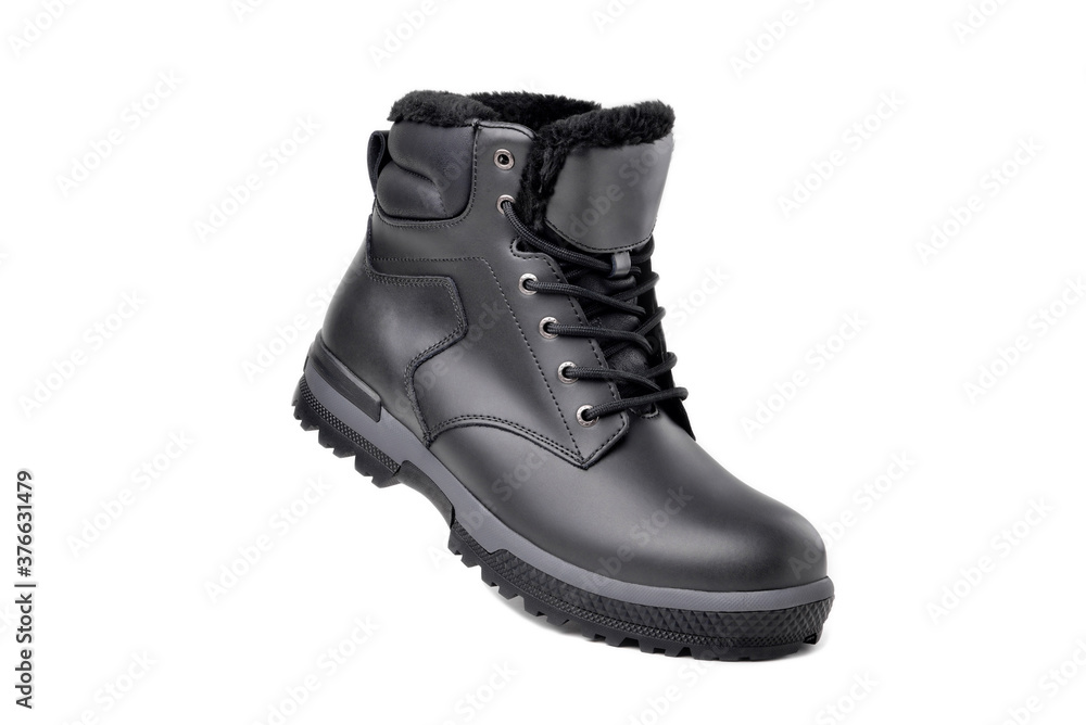 Winter male black leather boot on a white background, hiking shoes, practical off-road shoes, close-up Winter male black leather boot on a white background, hiking shoes, practical off-road shoes, close-up