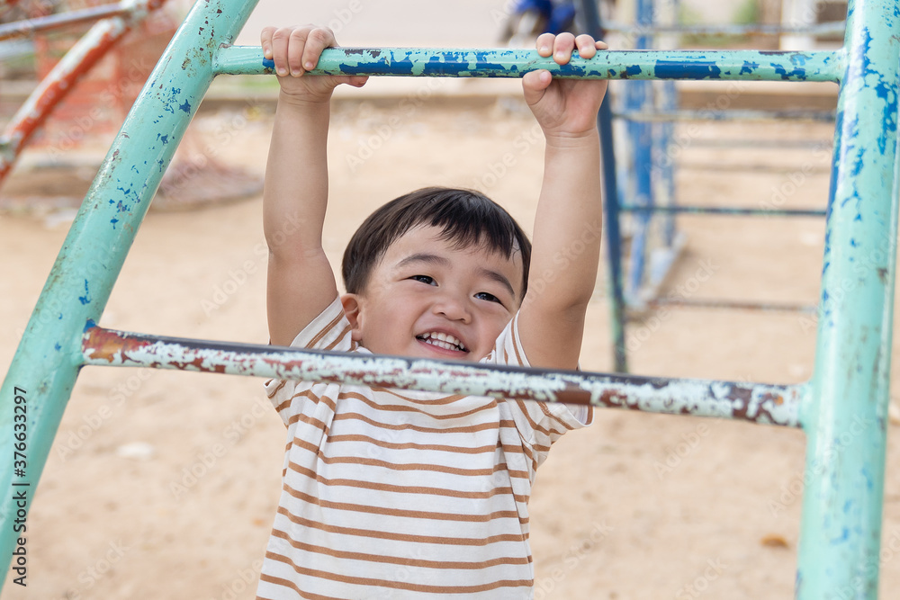 Fototapeta premium Asian little baby boy enjoy with outdoor zone kid park.