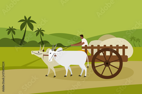 A villager transports goods in a bullock cart in rural India