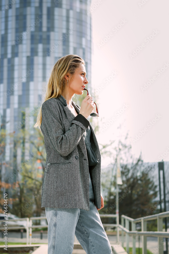 Young business woman standing outside a office building. Portrait of successful business woman Young business woman standing outside a office building. Portrait of successful business woman