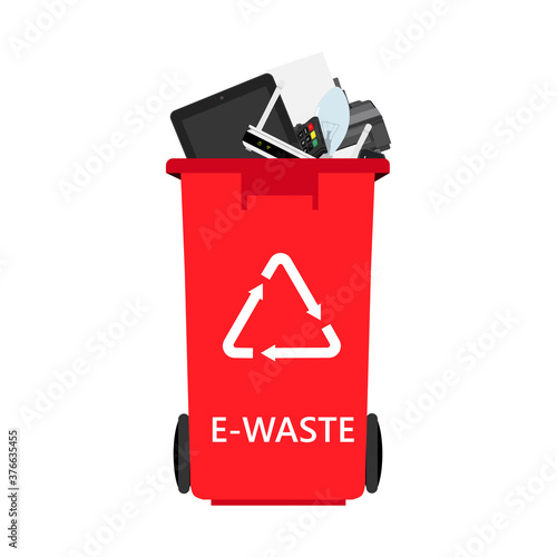 Electronic waste in red recycling bin with discarded electrical and electronic devices