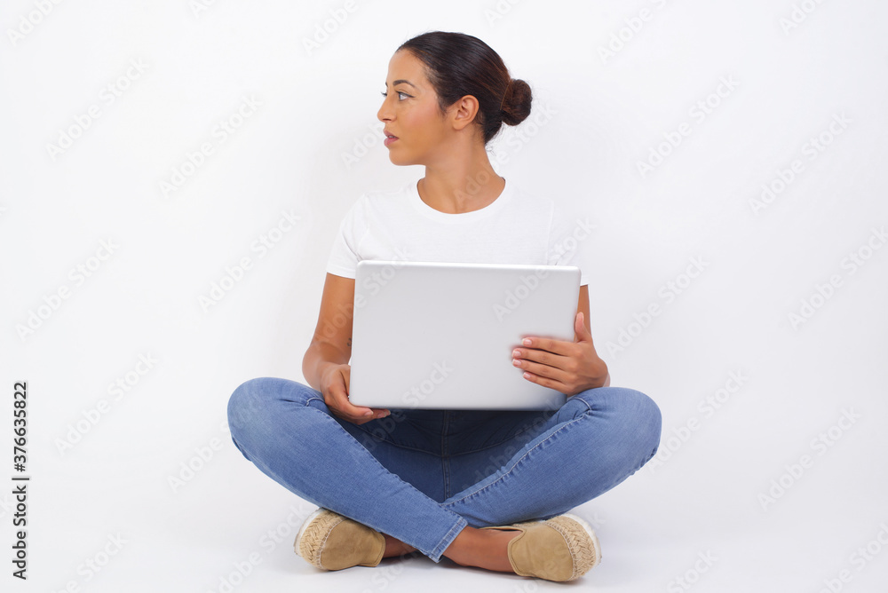 Profile of serious woman with healthy pure skin has contemplative expression ready to have outdoor walk isolated over grey studio wall with copy space. Profile of serious woman with healthy pure skin has contemplative expression ready to have outdoor walk isolated over grey studio wall with copy space.