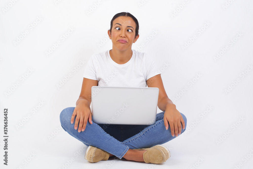 Funny comic girl crosses eyes, puts lips, makes grimace, foolishes after all day studying. Clueless woman nerd with awkward expression has fun alone, plays fool. Funny comic girl crosses eyes, puts lips, makes grimace, foolishes after all day studying. Clueless woman nerd with awkward expression has fun alone, plays fool.