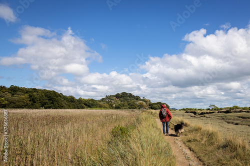 Woman walking her dog on a hiking trail