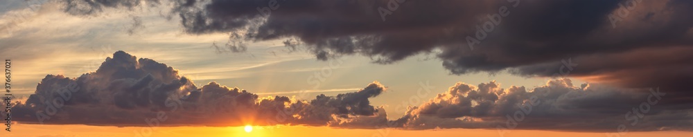 Amazing panoramic cloudscape at sunset in Belize, Central America. Beautiful warm orange and blue colors.