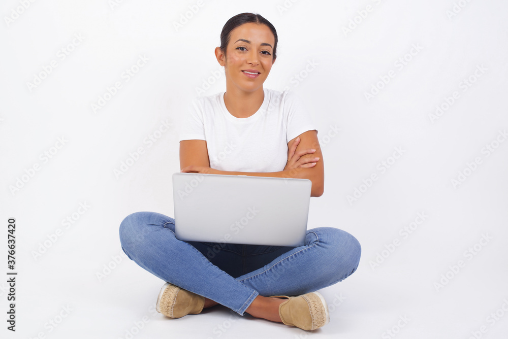 Image of cheerful pretty young caucasian businesswoman standing indoors with arms crossed. Looking and smiling at the camera. Confident girl. Image of cheerful pretty young caucasian businesswoman standing indoors with arms crossed. Looking and smiling at the camera. Confident girl.