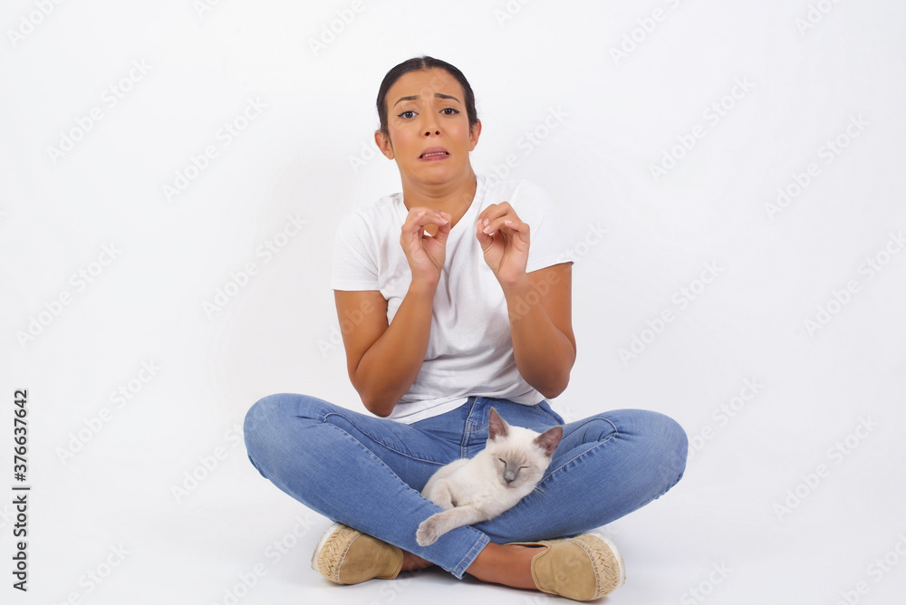 Ugh how disgusting! Displeased young woman dressed casual, says fie and has dissatisfied facial expression as sees something abominable or detestable, isolated over  background.