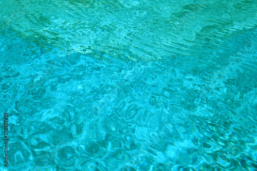Water pattern in swimming pool. © pavelalexeev