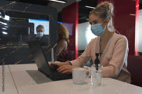 Group of business people wear face mask and work in social distance with partitions in between as a part of new normal during coronavirus covid 19 in the meeting room at office workplace