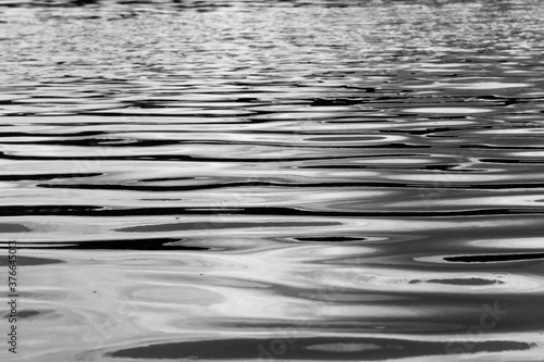 Blurred abstracted water surface in black and white mode with selective focus 