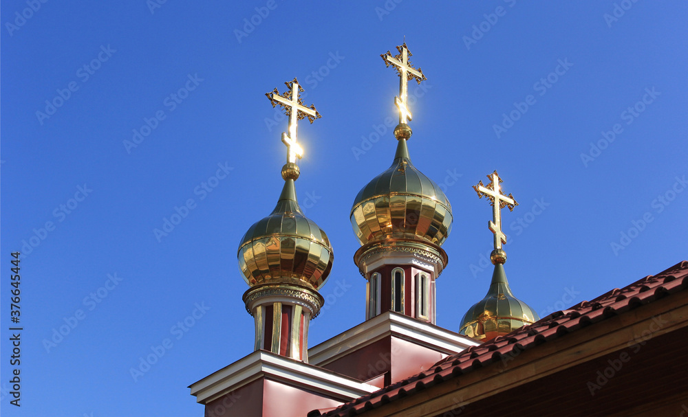 Three Orthodox crosses against the background of a blue summer sky Three Orthodox crosses against the background of a blue summer sky