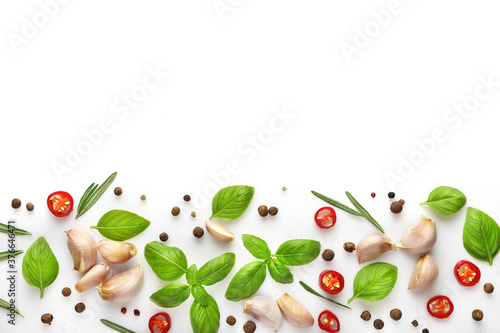 Ingredients for cooking, garlic, pepper, spices and herbs isolated on white background. Top view. Copy space.