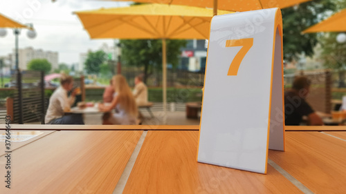 the order number on the table on the street in a McDonald's restaurant. Awaiting an order at a McDonald's restaurant. Fast food with invoice, check. 