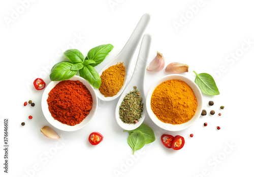 Fototapeta Naklejka Na Ścianę i Meble -  Top view of various spices in bowls and spoons isolated on white background.
