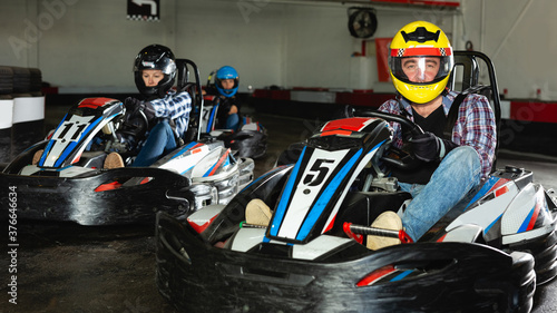 active people driving sport cars for karting in a circuit lap in sport club