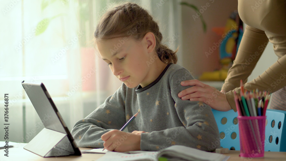Cute children use laptop for education, online study, home studying, Boy and Girl have homework at distance learning. Lifestyle concept for home schooling. Mother helps daughter and son. Cute children use laptop for education, online study, home studying, Boy and Girl have homework at distance learning. Lifestyle concept for home schooling. Mother helps daughter and son.