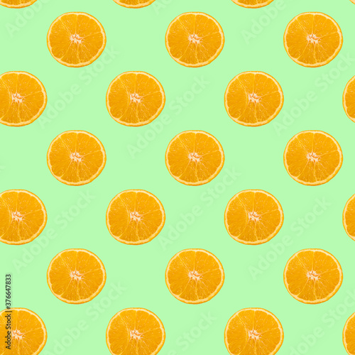 A pattern of sliced orange circles on a light green background.