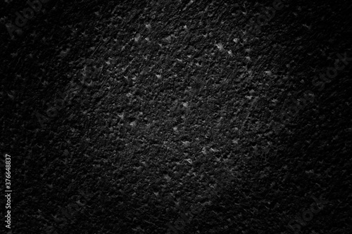 Dark black concrete rough grain texture pattern cool background