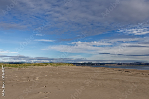 The wide sandy deserted beach of Tentsmuir Point on the southern edge of the Tay Estuary  looking North towards Broughty Ferry 