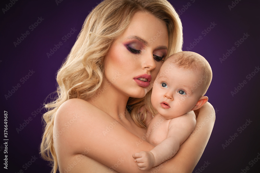 portrait of a beautiful blonde girl with skillful makeup with a baby close-up portrait of a beautiful blonde girl with skillful makeup with a baby close-up