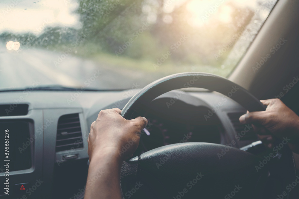 closeup hand driver car on road