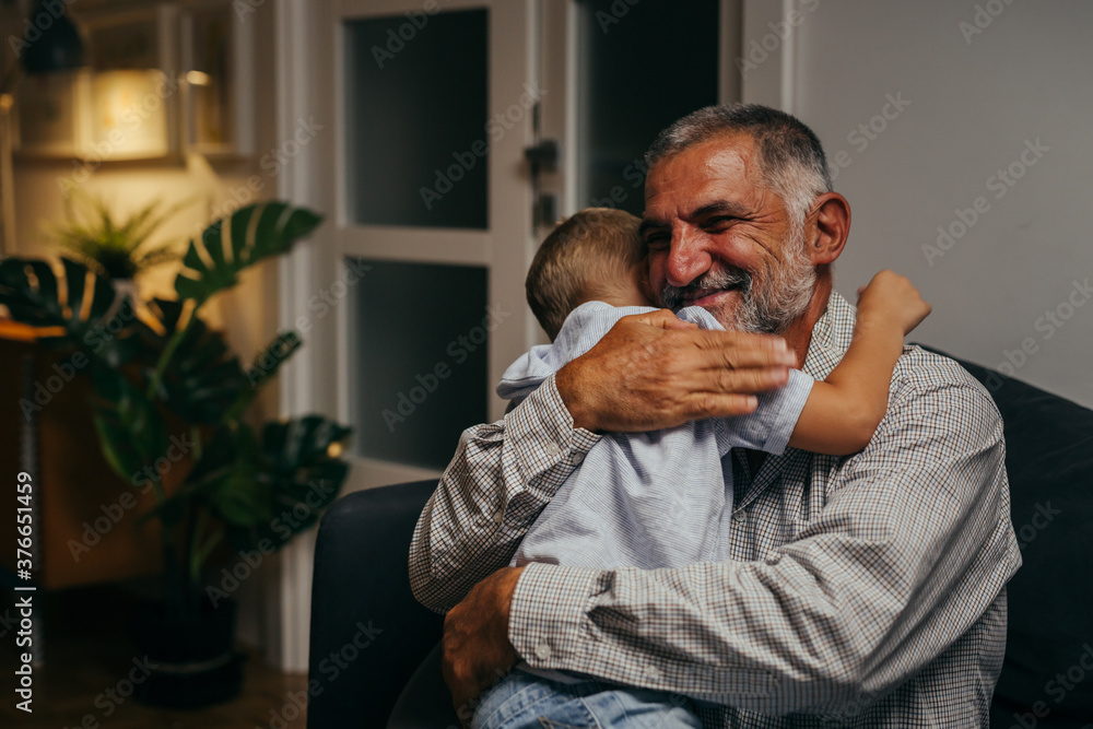 grandfather and his grandson hugging grandfather and his grandson hugging