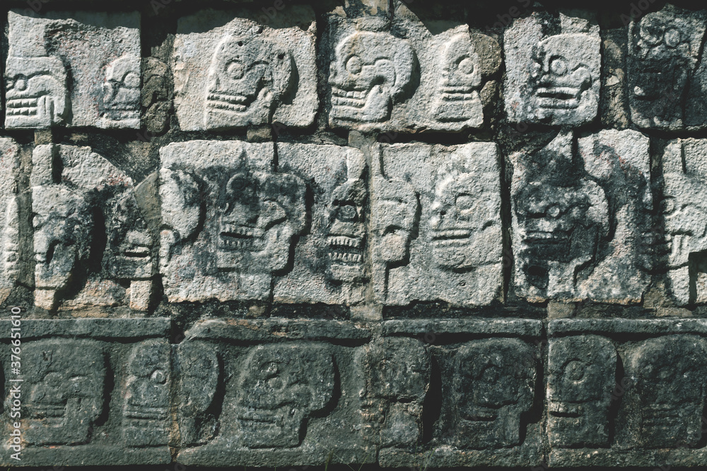 Closeup of carved skulls in a Mayan temple in Chichen Itza, Yucatan, Mexico