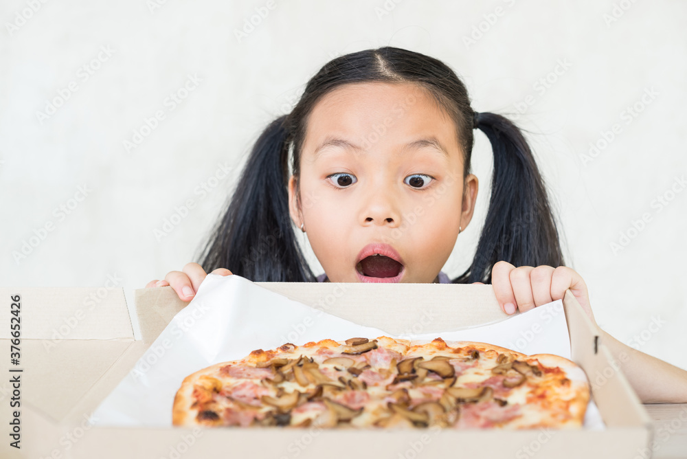cute little girl holds piece of pizza, hungry student opens mouth wide while sees delicious slice of pizza, wants to eat, positive woman with junk food, people and eating, people and snack concept. cute little girl holds piece of pizza, hungry student opens mouth wide while sees delicious slice of pizza, wants to eat, positive woman with junk food, people and eating, people and snack concept.