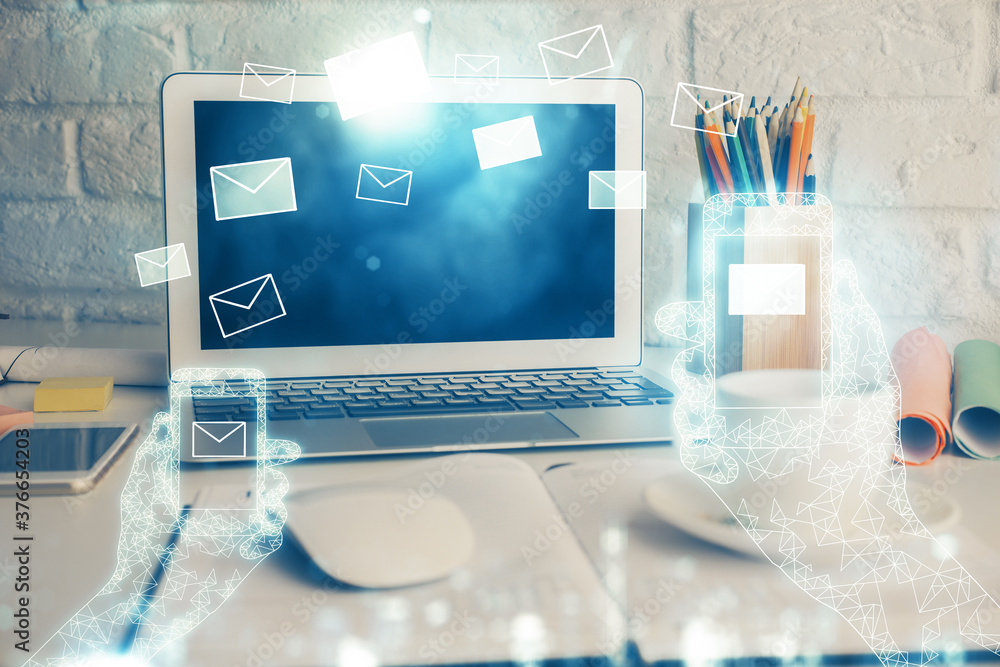 Desktop computer background in office and flying envelops hologram drawing. Double exposure. Electronic mail concept. Desktop computer background in office and flying envelops hologram drawing. Double exposure. Electronic mail concept.