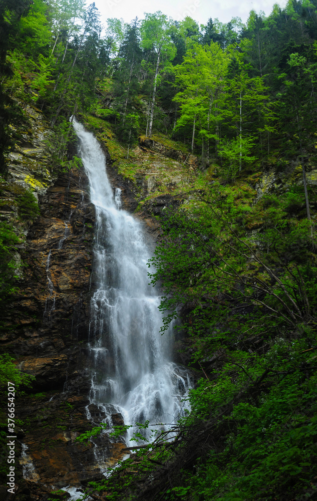 Scorusu Waterfall flowing through Capatanii Mountains. It is a wild 40 meters high waterfall. Carpathian Mountains, Romania.