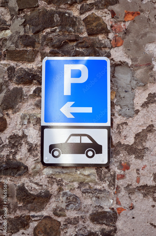 Close Up of Metal Parking Signs on Old Stone Wall Close Up of Metal Parking Signs on Old Stone Wall